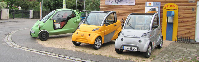Image of 3 Electric Golf Carts Being Charged, Golf carts being charged, electric golf carts, EV integration, electric vehicles, Highest Good transportation, eco-living, green living, sustainable transportation, community vehicles, Highest Good energy, One Community, One Community global
